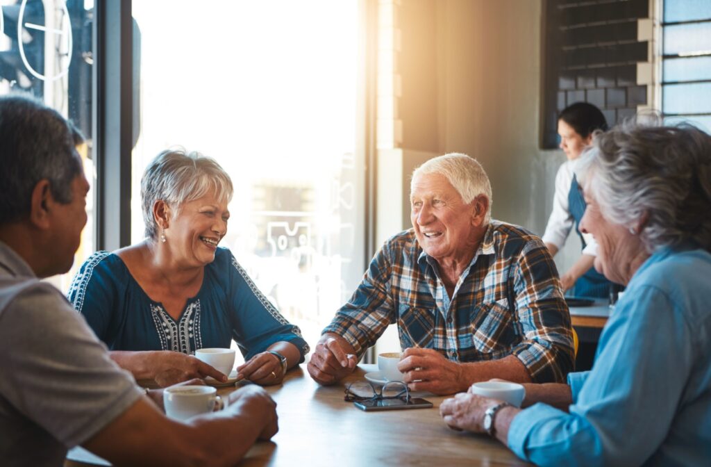 Seniors at an independent living community enjoying a coffee surrounded by friends