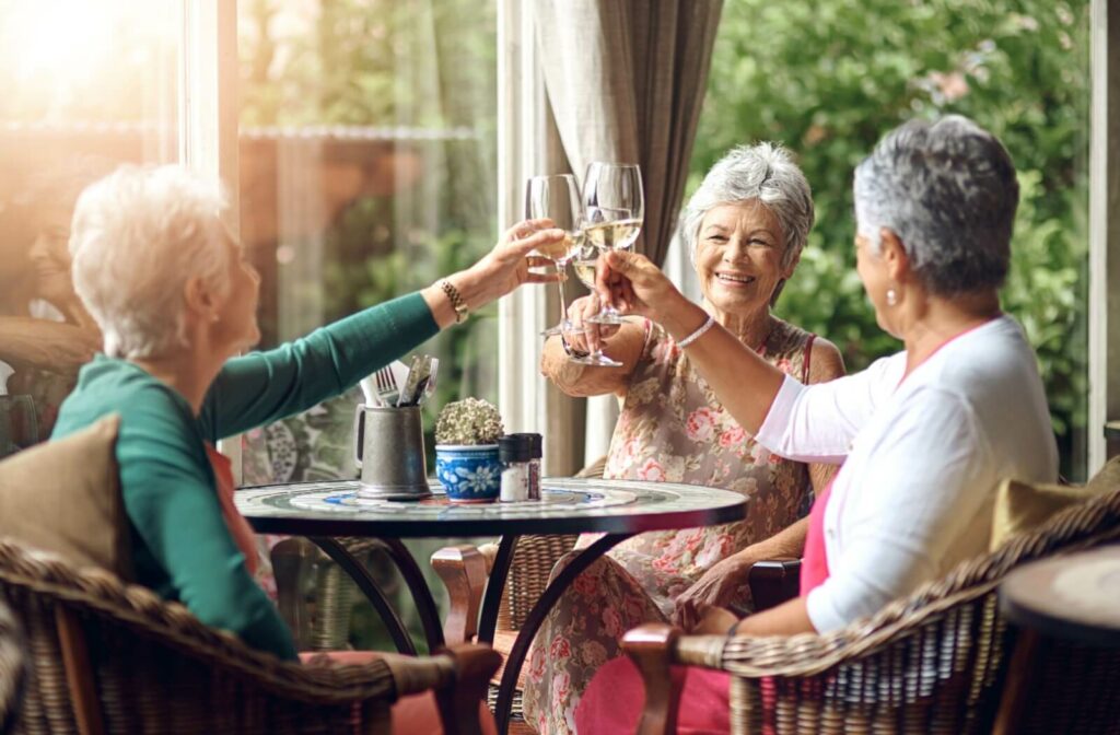 Seniors at a senior living community enjoying a glass of wine together