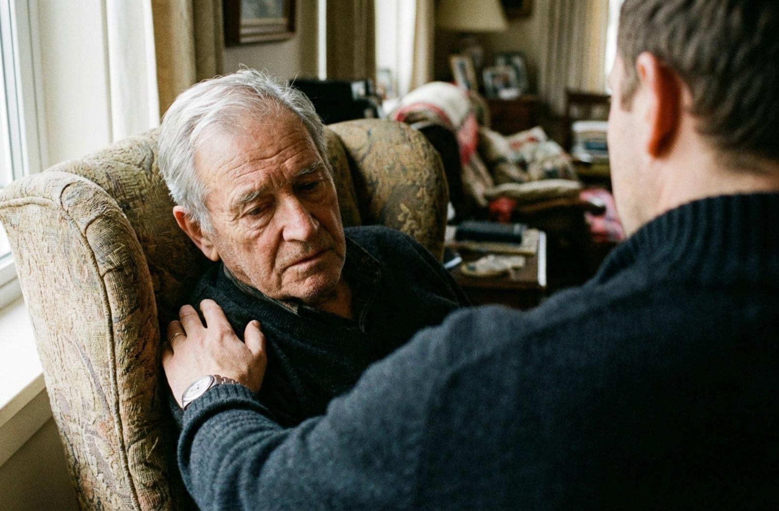 Close-up of a younger person's hand gently resting on the arm of an older adult who appears confused, depicting patient non-verbal communication.
